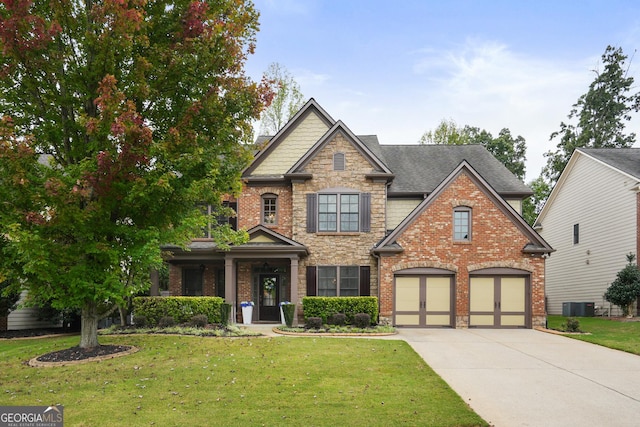 craftsman-style home with central AC unit, a garage, concrete driveway, stone siding, and a front yard