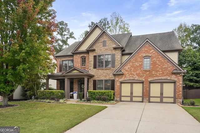 craftsman-style home with driveway, a shingled roof, stone siding, a front lawn, and brick siding