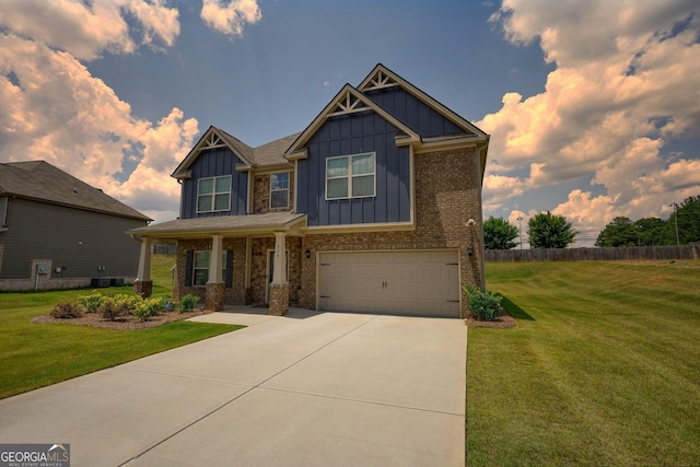 craftsman-style home with board and batten siding, a front yard, driveway, and an attached garage