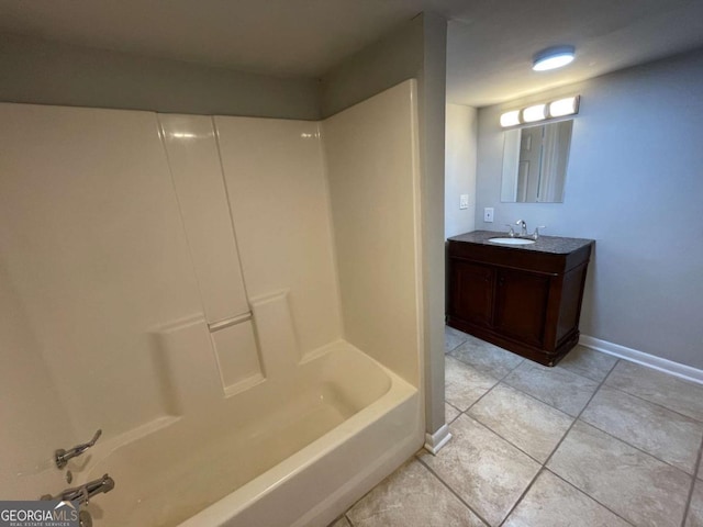 bathroom featuring tub / shower combination, vanity, baseboards, and tile patterned floors