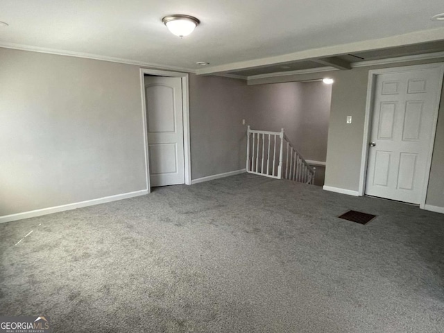 below grade area with ornamental molding, carpet flooring, and baseboards