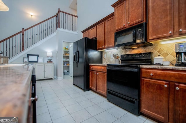 kitchen featuring black appliances, light countertops, and light tile patterned flooring