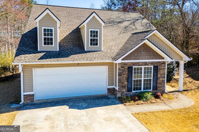 view of front facade with an attached garage, concrete driveway, and roof with shingles