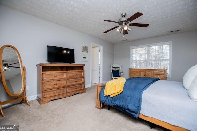 bedroom featuring baseboards, a textured ceiling, visible vents, and carpet flooring