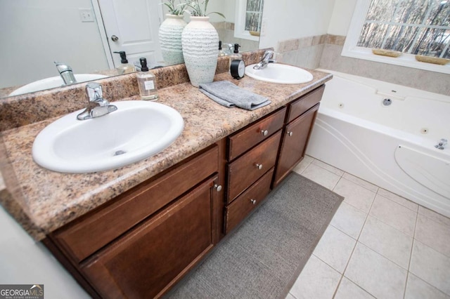 full bath with double vanity, tile patterned flooring, a sink, and a whirlpool tub