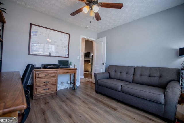 office area featuring ceiling fan, a textured ceiling, and wood finished floors