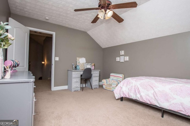 bedroom featuring a ceiling fan, light carpet, vaulted ceiling, a textured ceiling, and baseboards