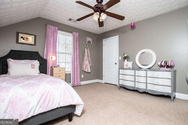 carpeted bedroom featuring baseboards, visible vents, vaulted ceiling, and a textured ceiling