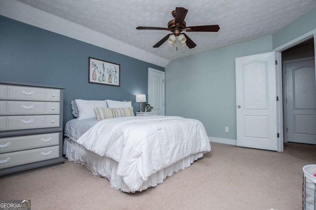 carpeted bedroom featuring a textured ceiling, ceiling fan, lofted ceiling, and baseboards