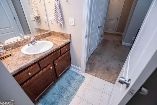 bathroom featuring vanity, baseboards, and tile patterned floors