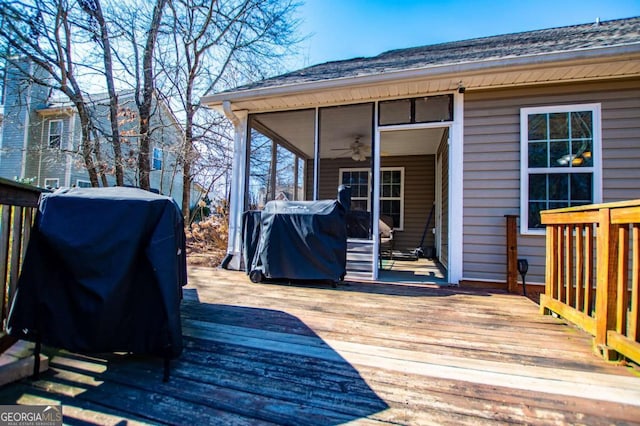 wooden terrace featuring grilling area and a sunroom