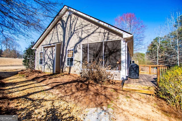 view of outbuilding featuring a sunroom