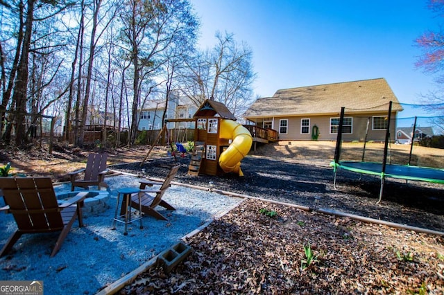 view of play area featuring a trampoline, a patio area, and fence