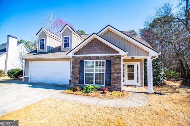 view of front of home featuring concrete driveway, stone siding, roof with shingles, an attached garage, and board and batten siding