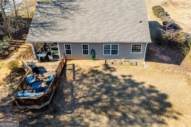 rear view of house featuring roof with shingles