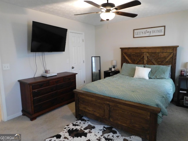 bedroom featuring baseboards, a ceiling fan, and light colored carpet