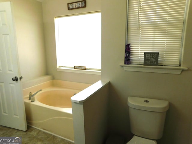 full bath featuring toilet and a bath