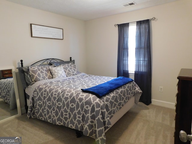 bedroom featuring carpet floors, visible vents, and baseboards