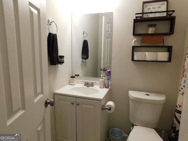 bathroom featuring vanity and toilet