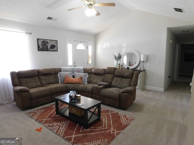 carpeted living area with lofted ceiling, ceiling fan, visible vents, and baseboards