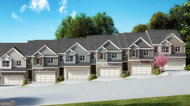 view of front of home with an attached garage, driveway, and board and batten siding