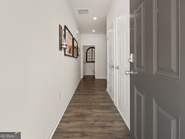 corridor featuring recessed lighting, visible vents, dark wood finished floors, and baseboards