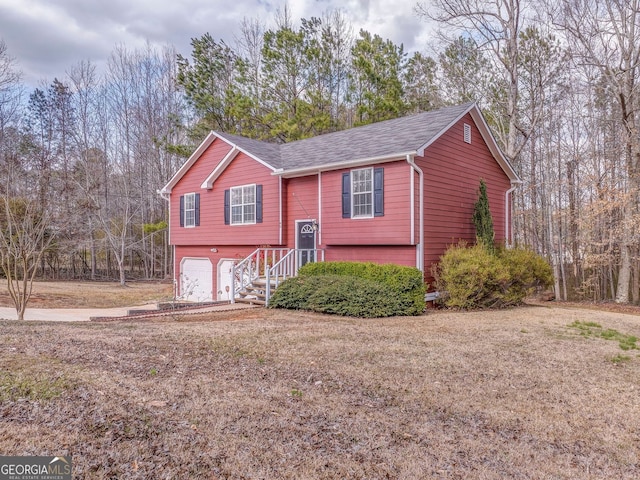 raised ranch featuring an attached garage