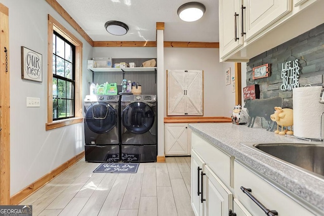 laundry room with baseboards, washer and clothes dryer, and wood tiled floor