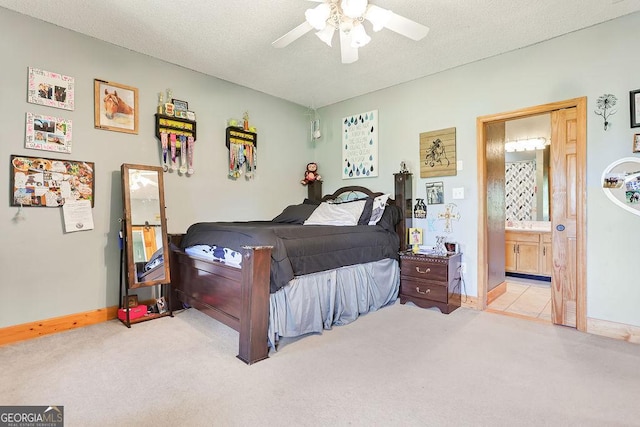 bedroom with a ceiling fan, carpet flooring, connected bathroom, and a textured ceiling