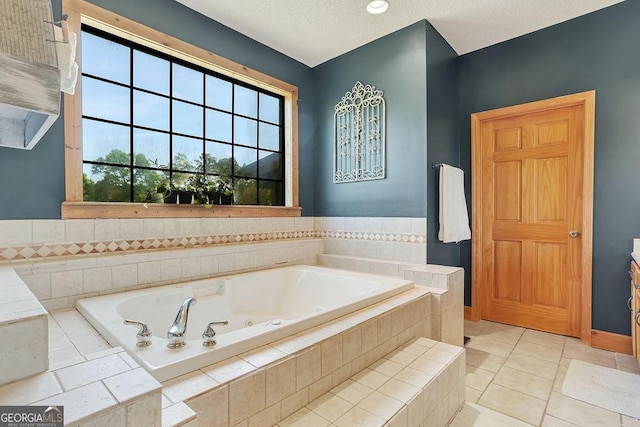 bathroom featuring a jetted tub, a textured ceiling, and tile patterned floors