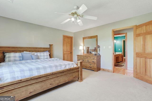 bedroom with light carpet, ceiling fan, a textured ceiling, and baseboards