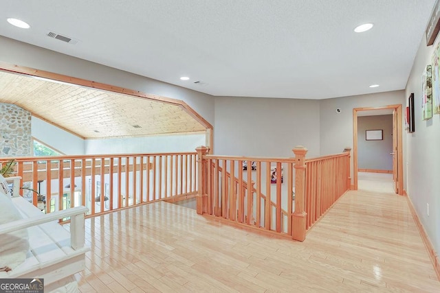 hall with recessed lighting, visible vents, baseboards, and wood finished floors