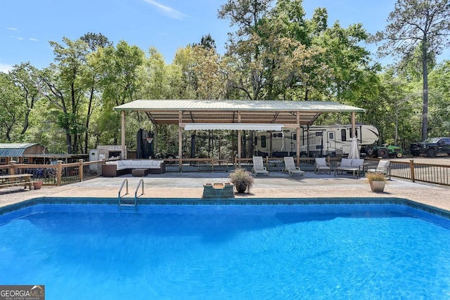 pool with fence, an outdoor hangout area, and a patio