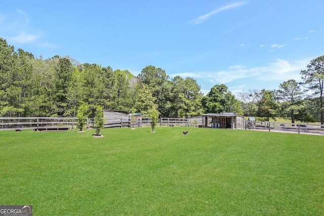 view of yard featuring fence and an outdoor structure