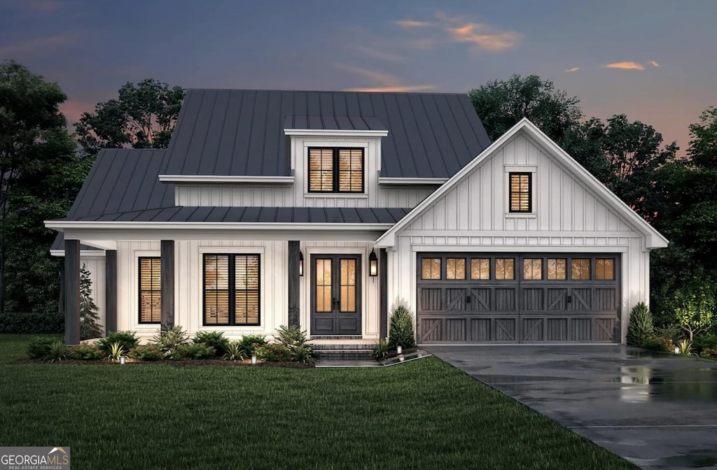 modern farmhouse style home featuring a garage, concrete driveway, metal roof, a standing seam roof, and board and batten siding