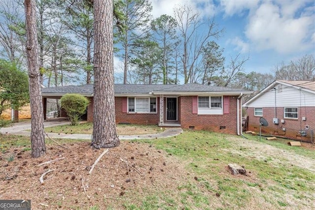 ranch-style home featuring an attached carport, brick siding, driveway, crawl space, and a front lawn