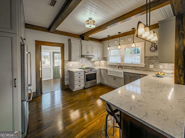 kitchen with light stone counters, dark wood-style floors, visible vents, backsplash, and appliances with stainless steel finishes