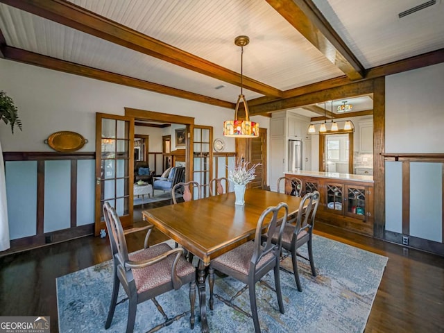 dining area featuring dark wood-style floors, french doors, visible vents, and beam ceiling