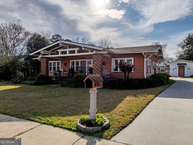 view of front of house featuring a front lawn and brick siding