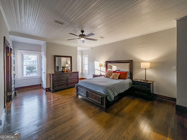 bedroom featuring visible vents, baseboards, wood-type flooring, ceiling fan, and crown molding