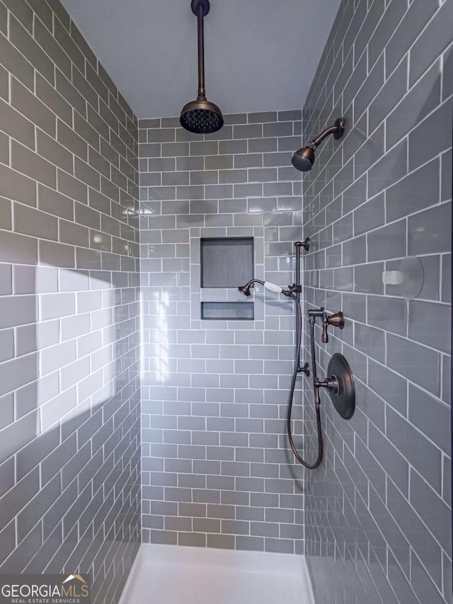 full bathroom with a tile shower