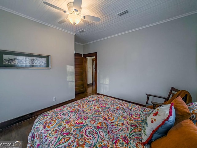 bedroom featuring baseboards, visible vents, ceiling fan, ornamental molding, and wood finished floors