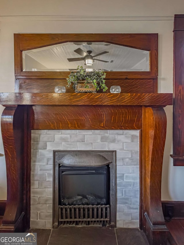 interior details featuring a fireplace and a ceiling fan