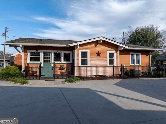 ranch-style home with a fenced front yard