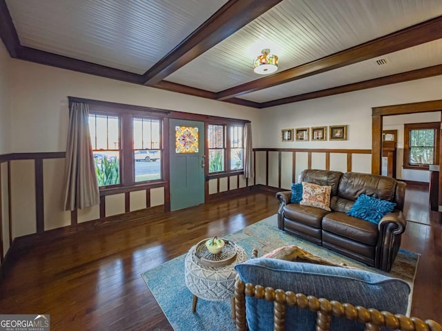 living room with beamed ceiling, wood-type flooring, and a wealth of natural light