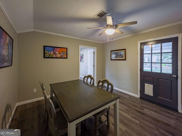 dining area with dark wood-style floors, ceiling fan, a textured ceiling, and crown molding