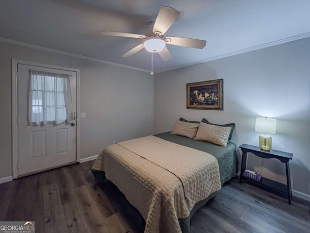 bedroom with ornamental molding, baseboards, and wood finished floors