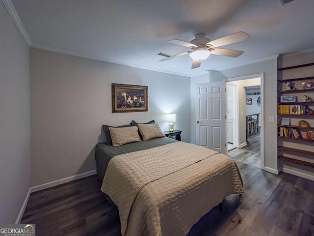 bedroom with dark wood-type flooring, visible vents, crown molding, and baseboards