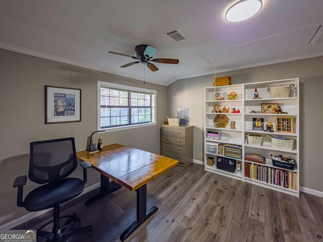 office space featuring attic access, crown molding, visible vents, and wood finished floors