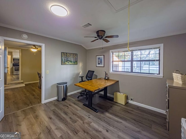 office space featuring crown molding, visible vents, attic access, wood finished floors, and baseboards